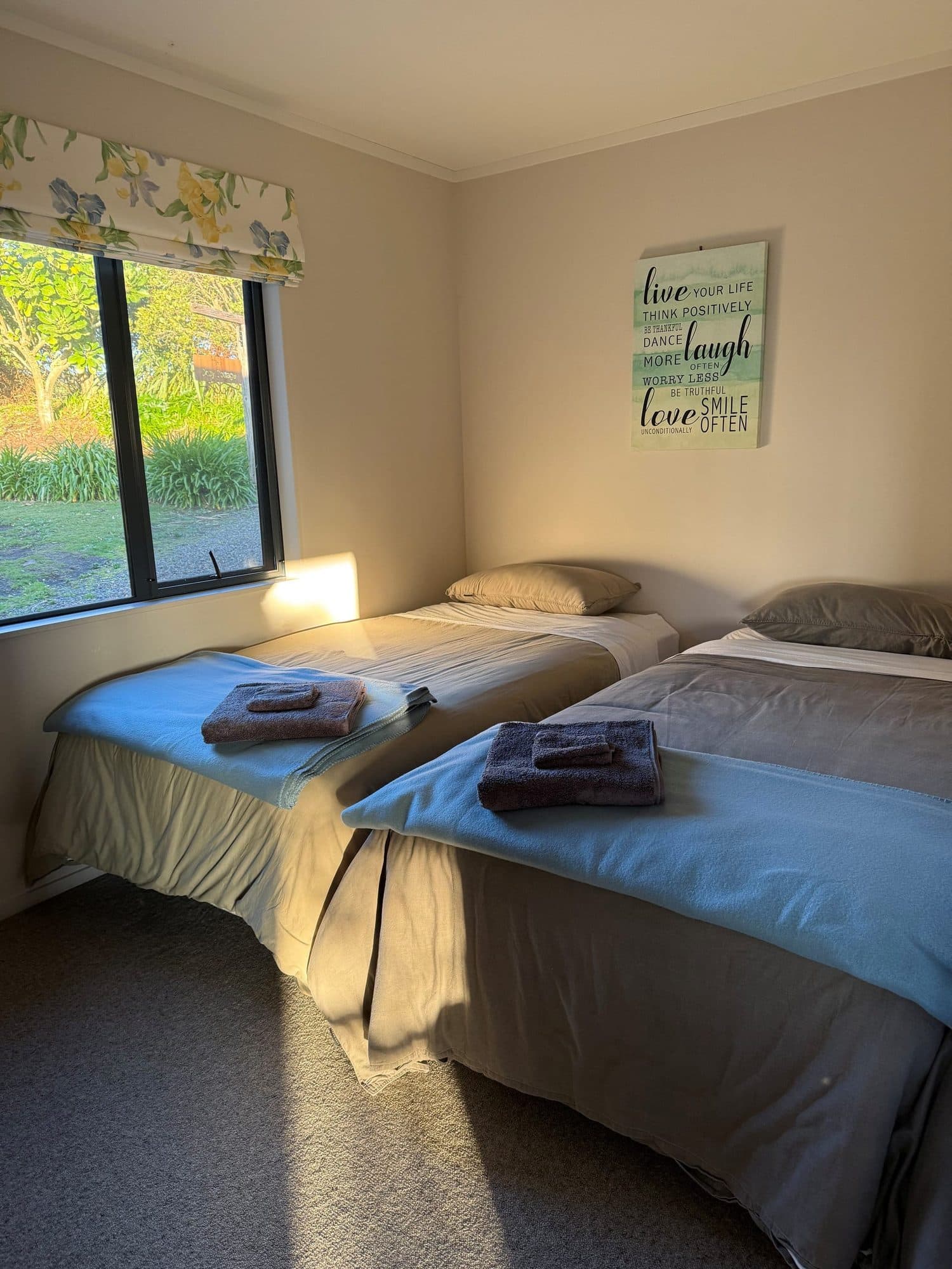 Second bedroom with two single beds made up with fresh towels